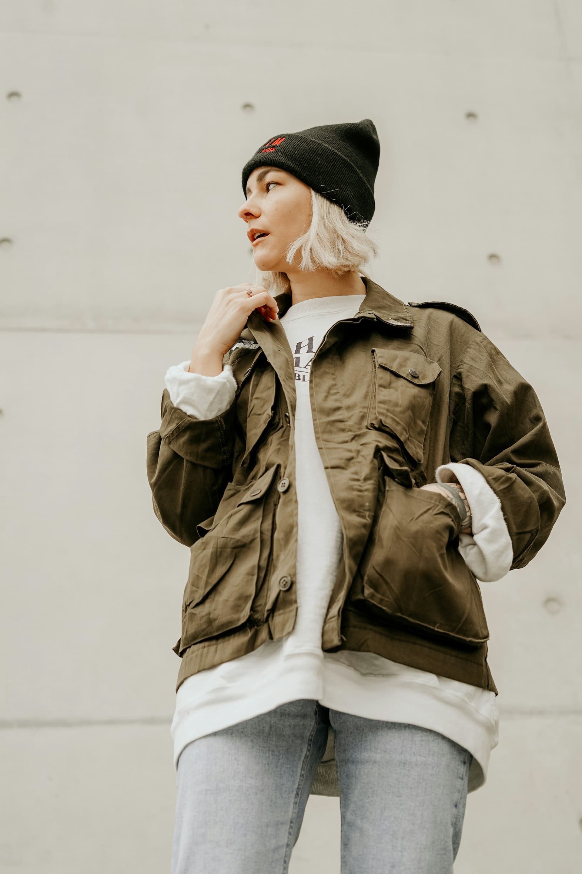 Street style portrait in an olive utility jacket and beanie