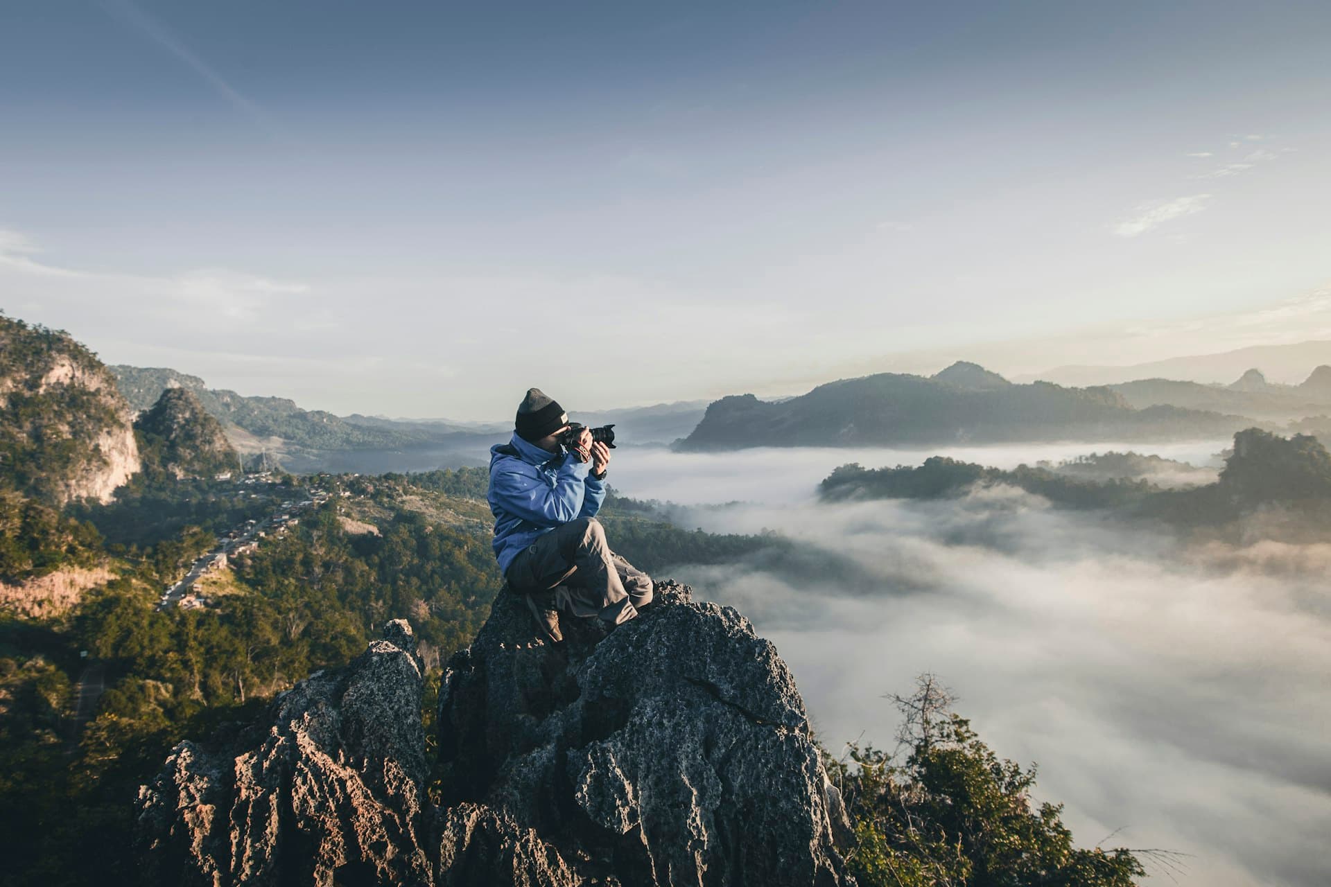 Photographer shooting outdoors above a misty valley